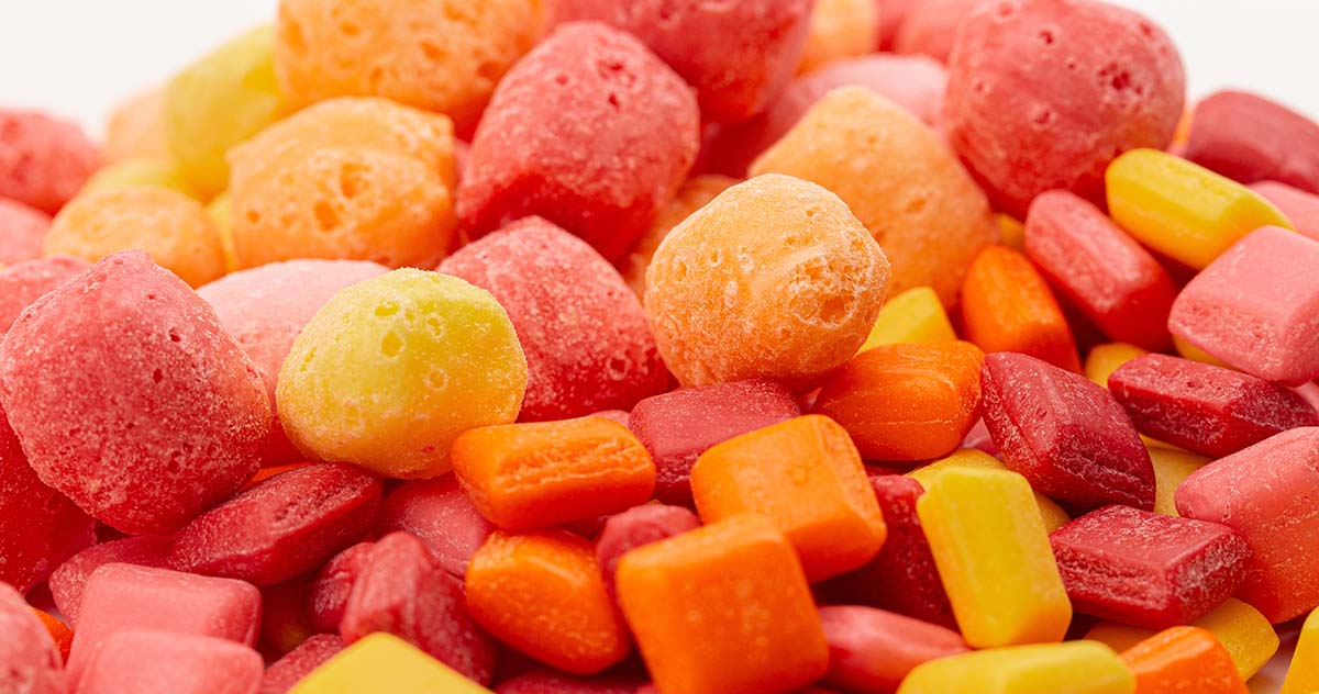 A selection of different freeze dried candies in an array of warm-toned colors.